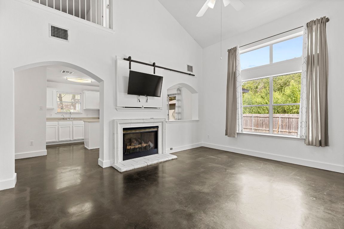 1886 Wallin Loop Round Rock, TX 78664 - Photo 6 of 28 a view of a livingroom with furniture a fireplace and wooden floor