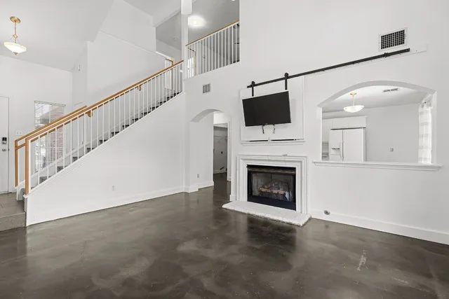 a living room with a fireplace and a flat screen tv