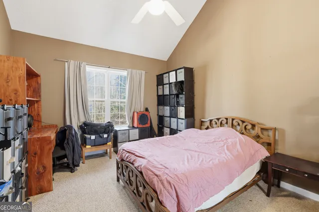 a bedroom with a bed a book shelf and a window
