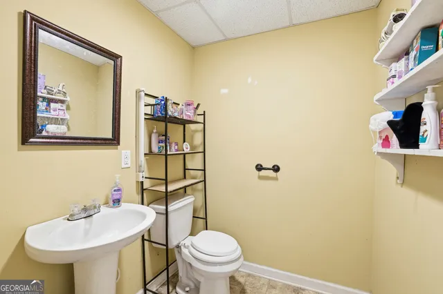 a bathroom with a sink mirror and toilet