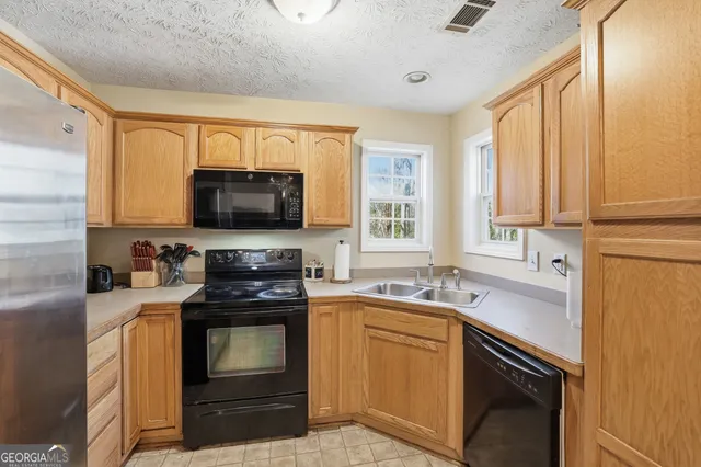 a kitchen with a sink stove and microwave