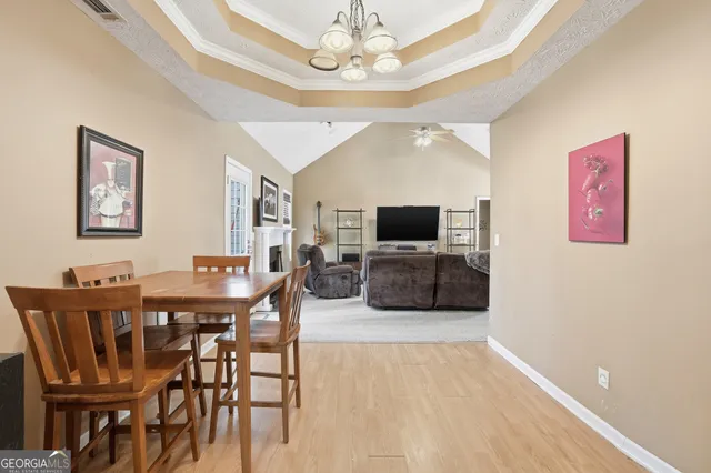 a view of a dining room with furniture and a chandelier