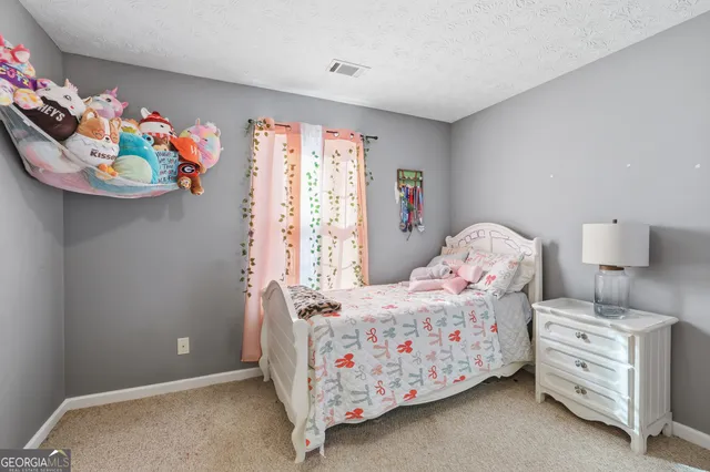 a bedroom with bed and window