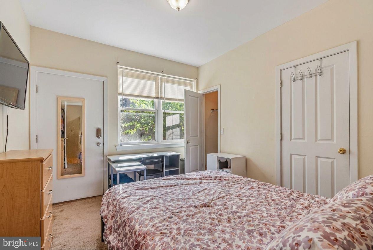 1724 Monument Street, Unit B Philadelphia, PA 19121 - Photo 11 of 26 a bedroom with a bed and a window with chair
