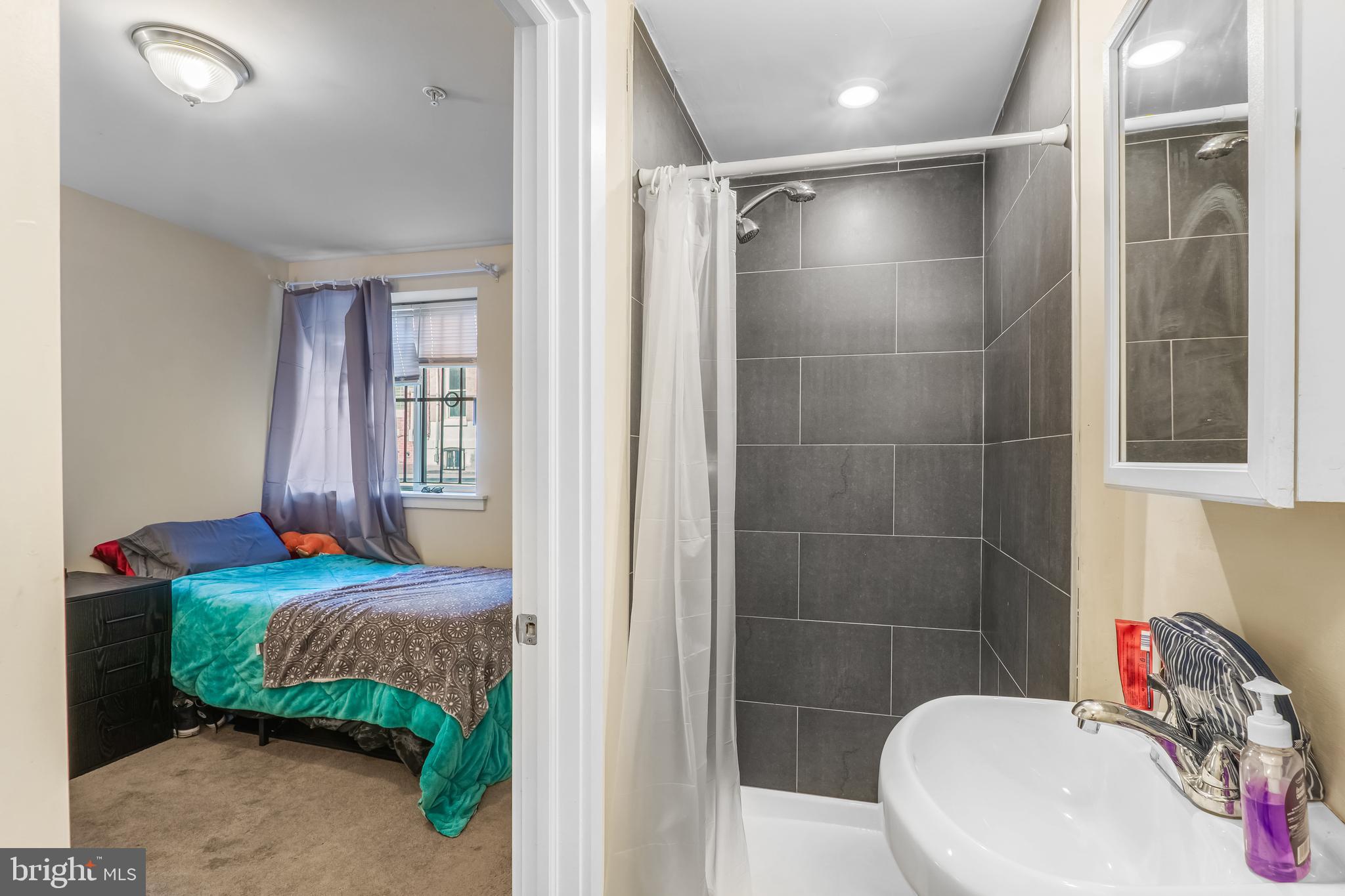 1724 Monument Street, Unit B Philadelphia, PA 19121 - Photo 16 of 26 a bathroom with a sink and a mirror