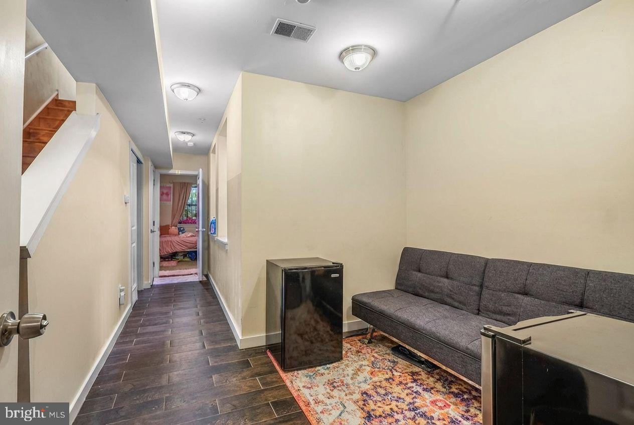 1724 Monument Street, Unit B Philadelphia, PA 19121 - Photo 18 of 26 a living room with furniture and a rug