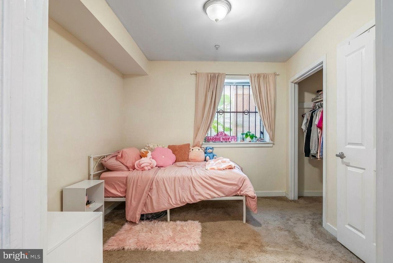 1724 Monument Street, Unit B Philadelphia, PA 19121 - Photo 19 of 26 a bedroom with a bed and a window
