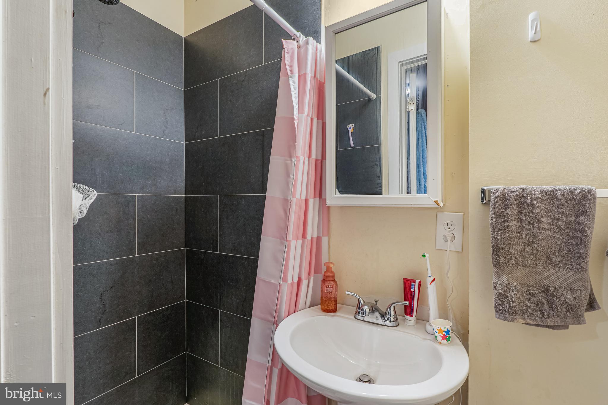 1724 Monument Street, Unit B Philadelphia, PA 19121 - Photo 8 of 26 a bathroom with a sink and a mirror