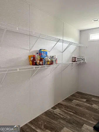 a view of a storage & utility room with racks on the wall