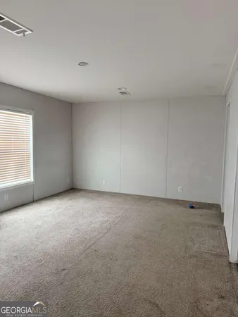 a view of an empty room and a window
