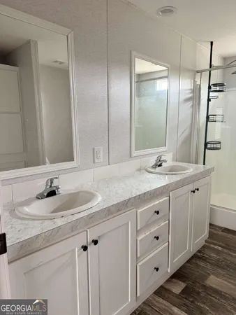 a bathroom with double sink and a mirror