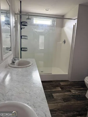 a bathroom with a glass shower door