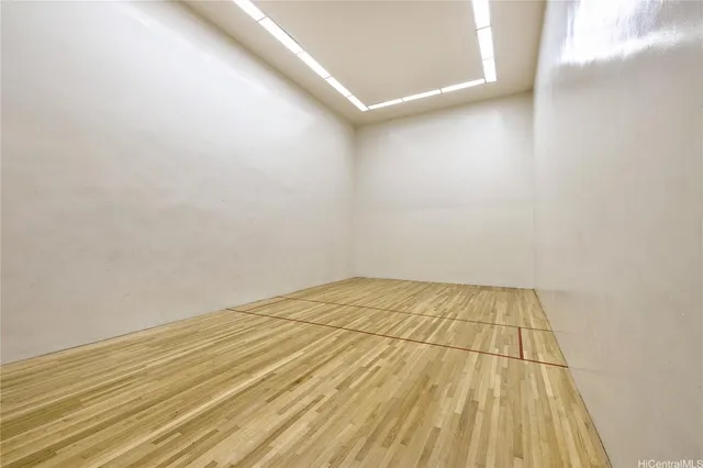 a view of a room with wooden floor and bench