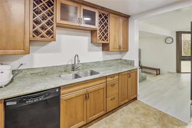 a kitchen with stainless steel appliances granite countertop a sink stove and cabinets