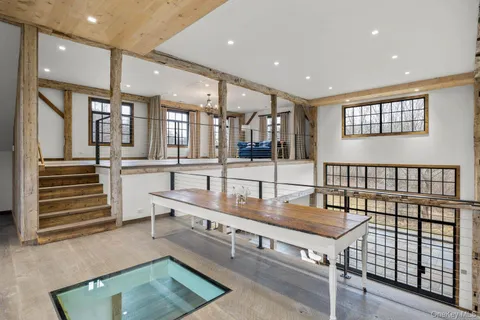 a living room with stainless steel appliances furniture