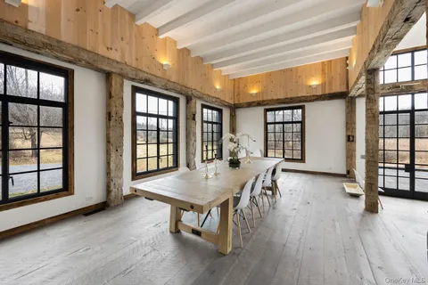 a dining room with wooden floor and entrance