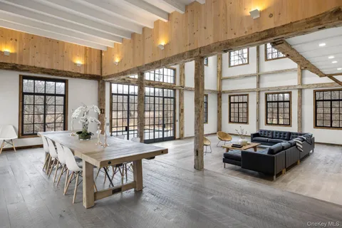 a living room with furniture and large windows