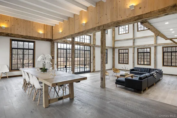 a building outdoor space with patio furniture and wooden floor