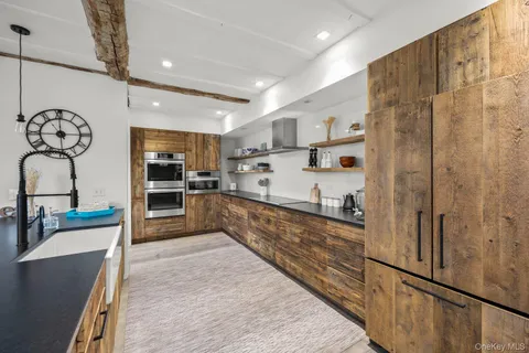 a large kitchen with a large counter top appliances and cabinets
