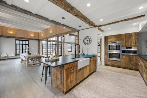 a large kitchen with stainless steel appliances lots of counter space and breakfast area