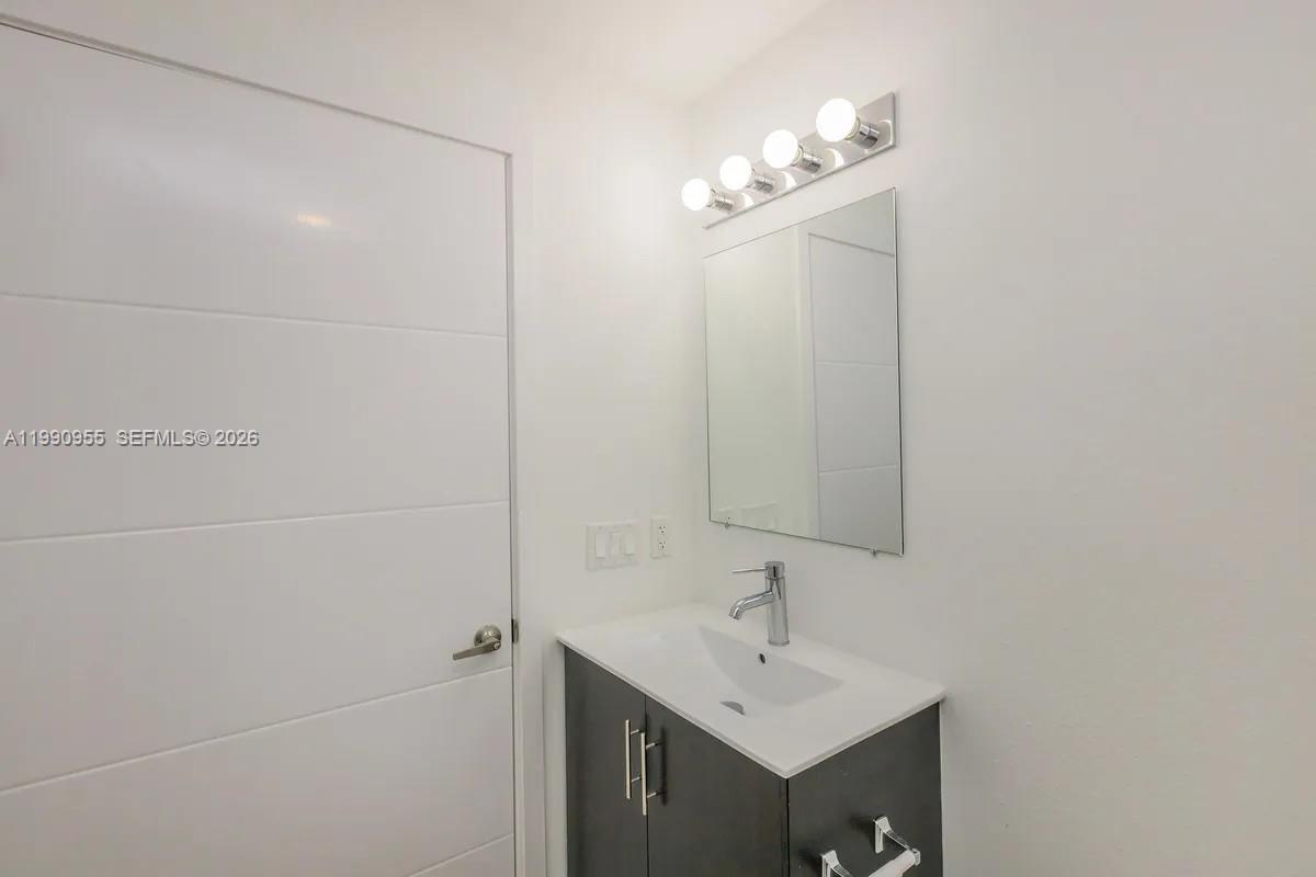 25850 Southwest 140th Court, Unit 6312 Homestead, FL 33032 - Photo 11 of 24 a bathroom with a sink a light fixture and a mirror