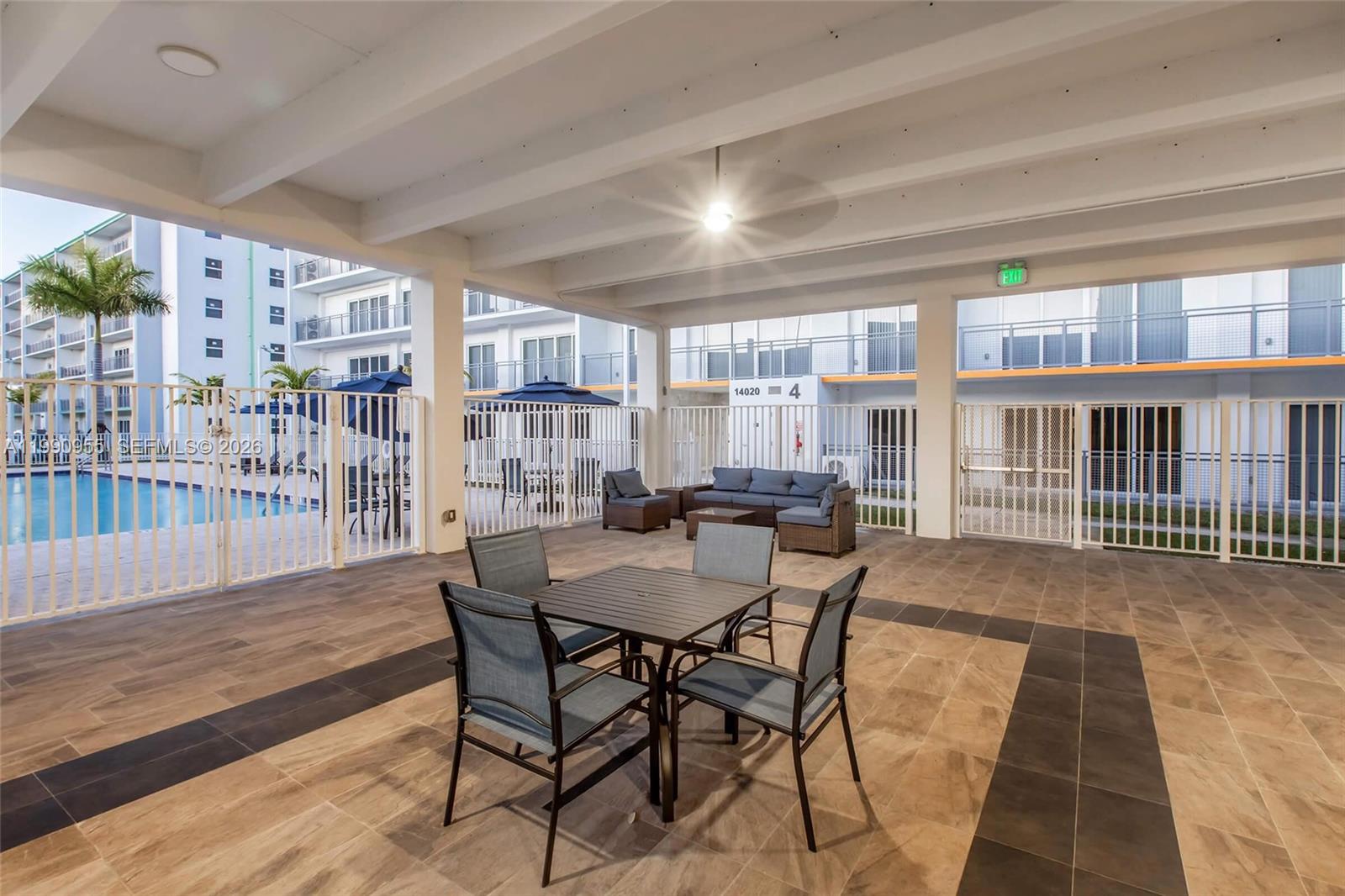 25850 Southwest 140th Court, Unit 6312 Homestead, FL 33032 - Photo 15 of 24 a view of a dining room with furniture and a floor to ceiling window