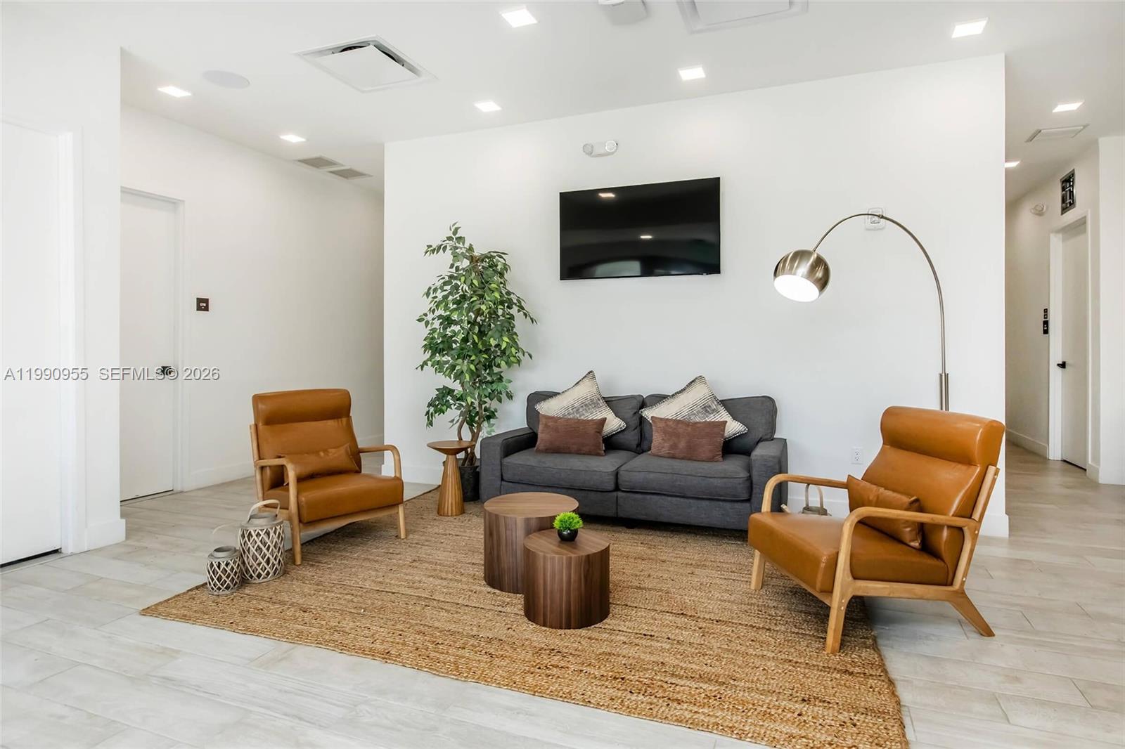 25850 Southwest 140th Court, Unit 6312 Homestead, FL 33032 - Photo 16 of 24 a living room with furniture and a flat screen tv