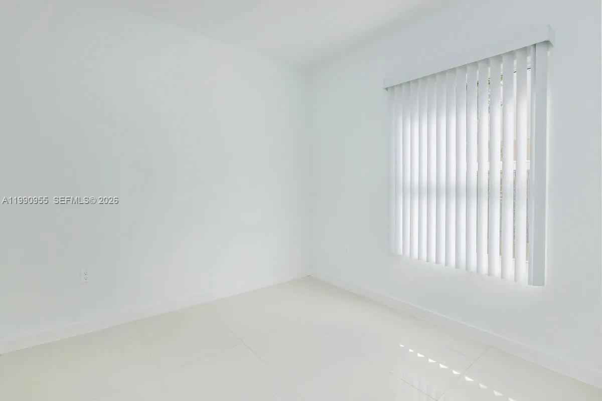 25850 Southwest 140th Court, Unit 6312 Homestead, FL 33032 - Photo 5 of 24 a view of an empty room with a window