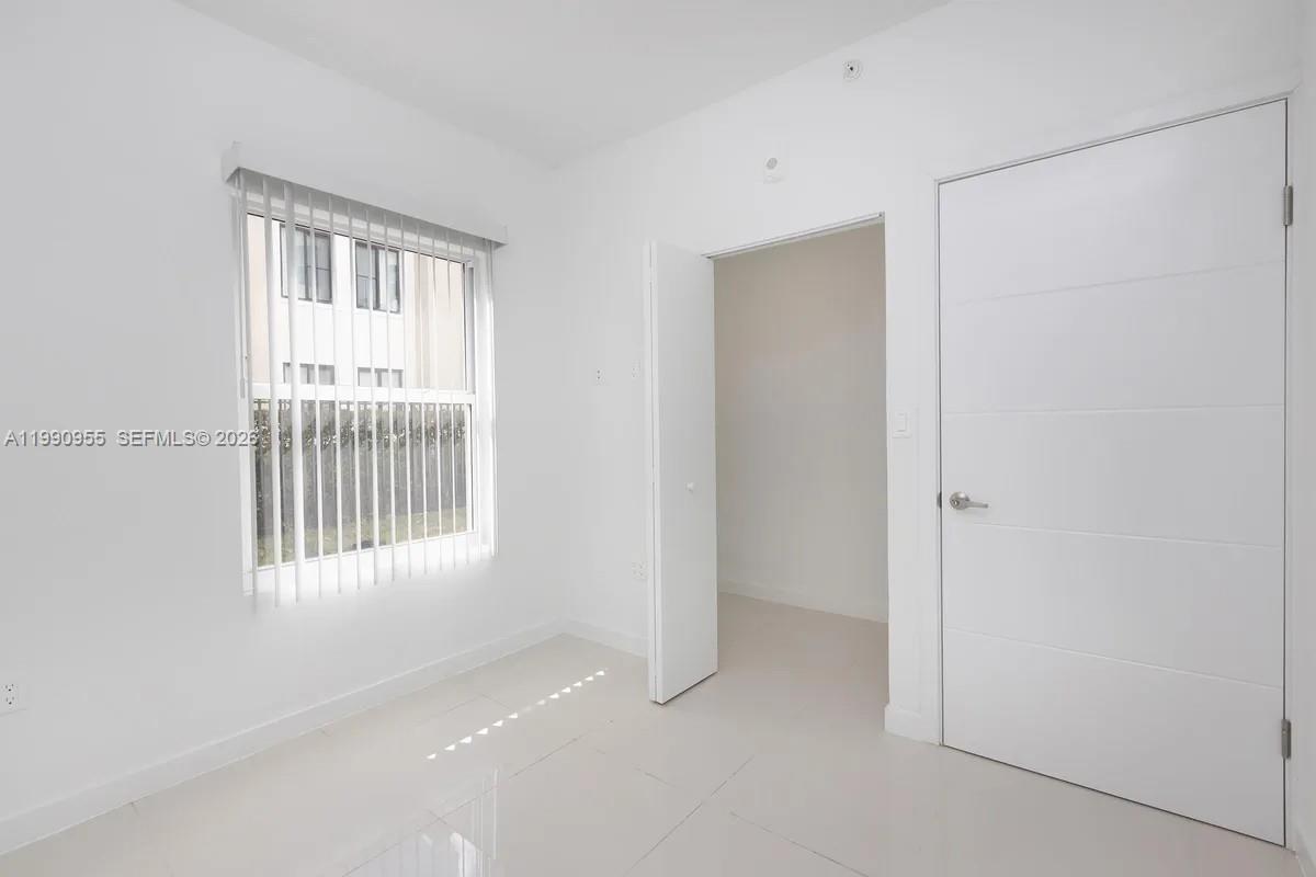 25850 Southwest 140th Court, Unit 6312 Homestead, FL 33032 - Photo 6 of 24 a view of an empty room with a window