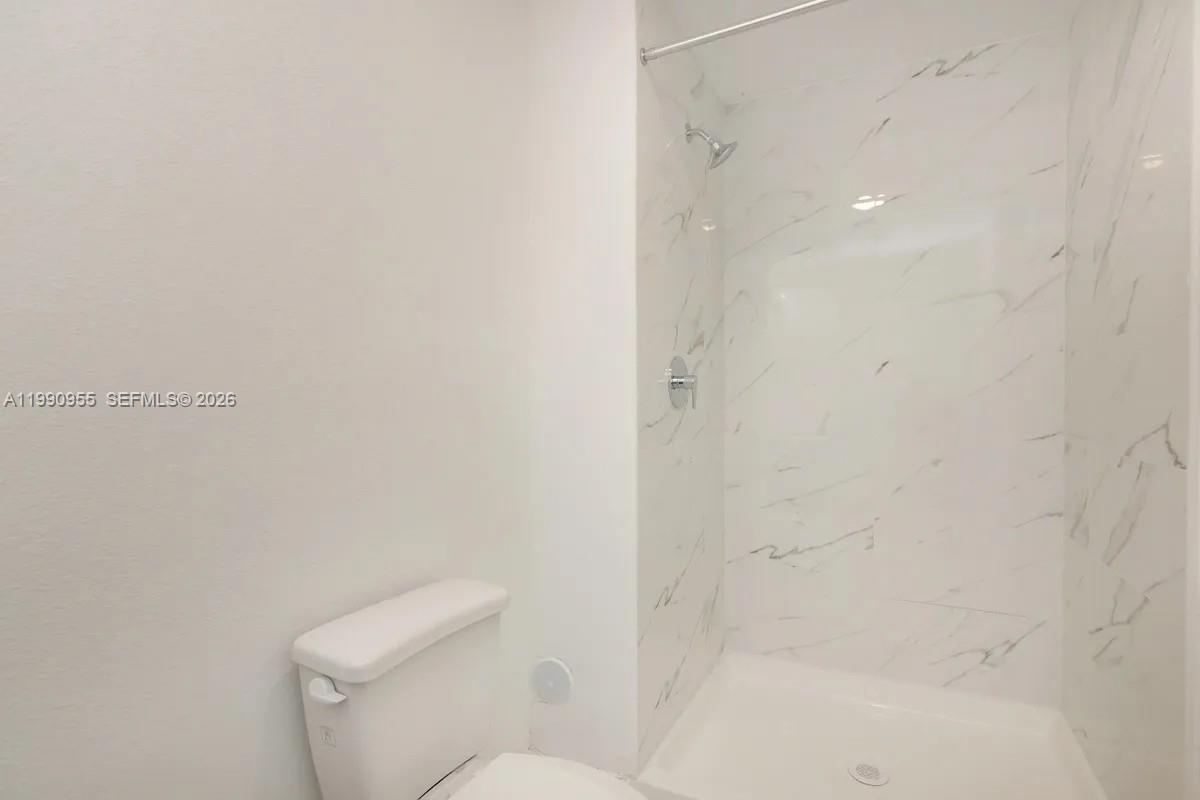 25850 Southwest 140th Court, Unit 6312 Homestead, FL 33032 - Photo 10 of 24 a bathroom with a toilet and shower