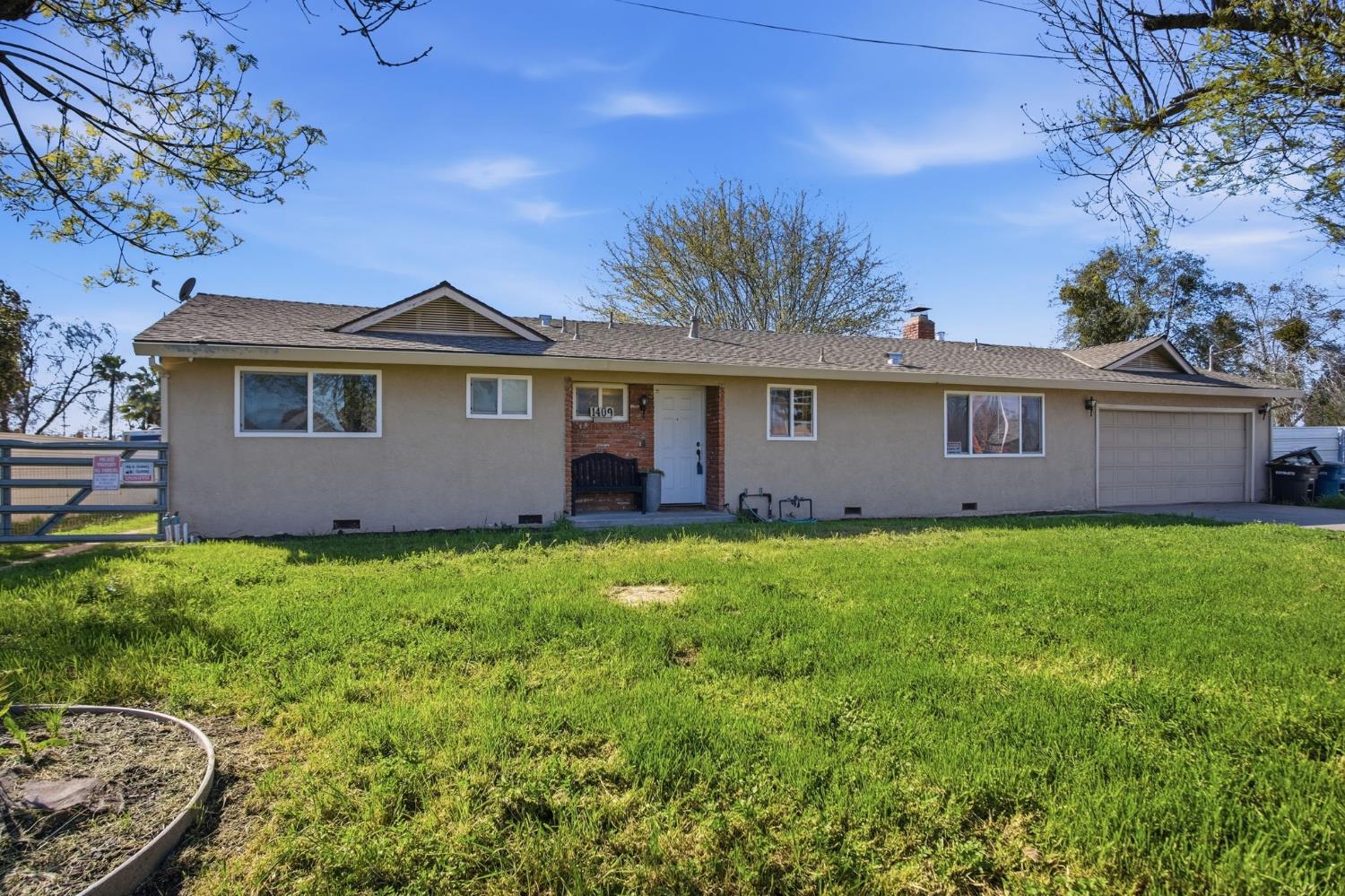 1409 Stonum Road Modesto, CA 95351 - Photo 5 of 40 a view of a house with a backyard