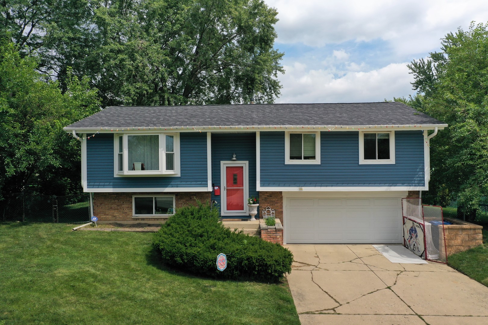 327 Springinsguth Road Schaumburg, IL 60193 - Photo 1 of 1 a front view of a house with a yard and garage