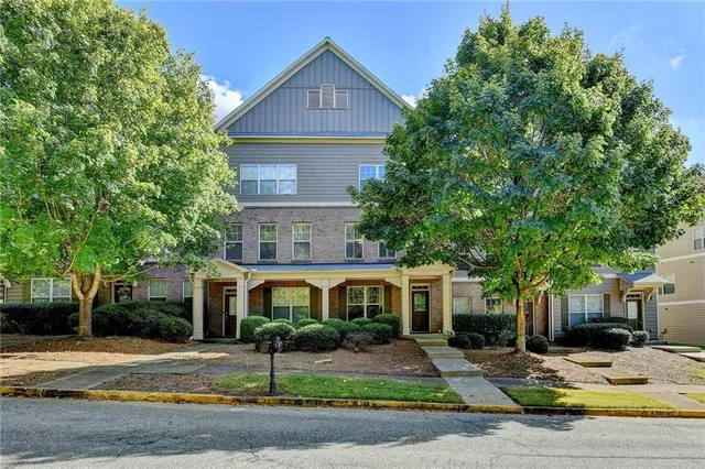 a view of a house with a garden and pathway
