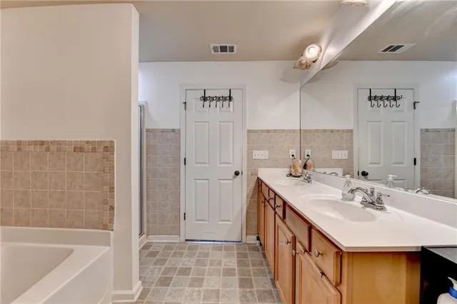a bathroom with a sink a mirror and a bathtub