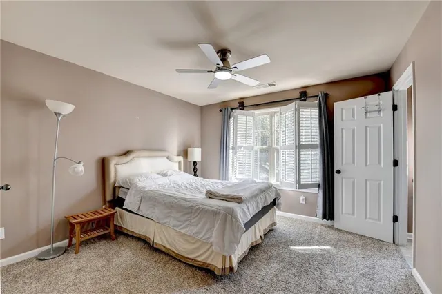 a a spacious bedroom with a bed and a window