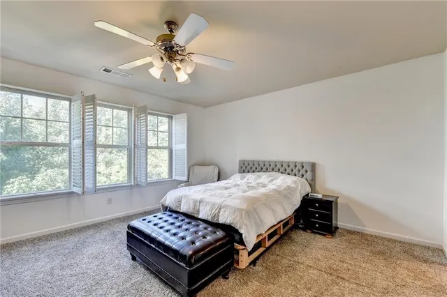 a bedroom with a bed and window
