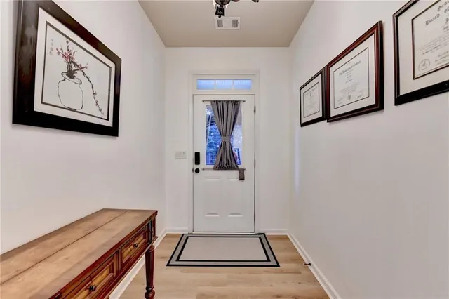 a view of an entryway with paintings on the wall