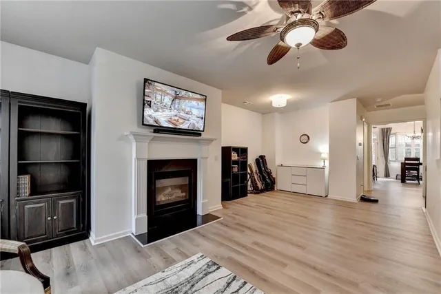 a view of a livingroom with a fireplace cabinet and window