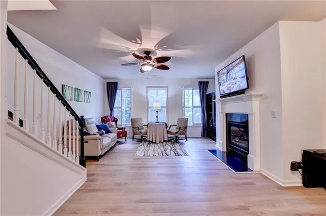 a living room with fireplace furniture and a wooden floor