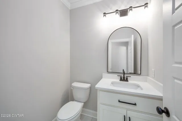 a bathroom with a sink mirror and toilet