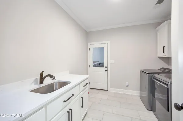 a kitchen with a sink and stainless steel appliances