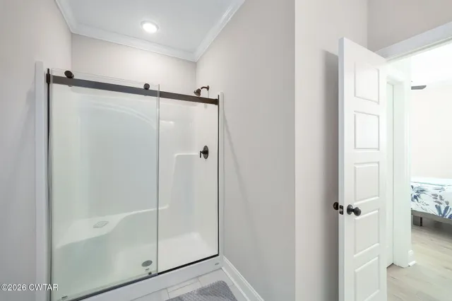 a bathroom with a glass shower door