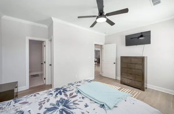 a bedroom with a bed and a dresser