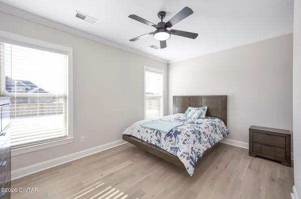 a bedroom with a large bed and a large window