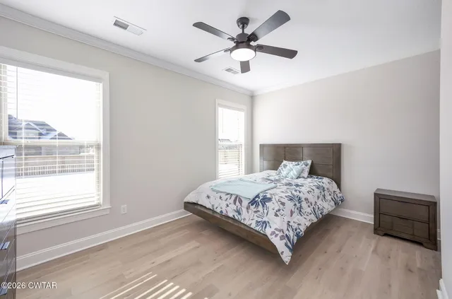 a bedroom with a large bed and a large window