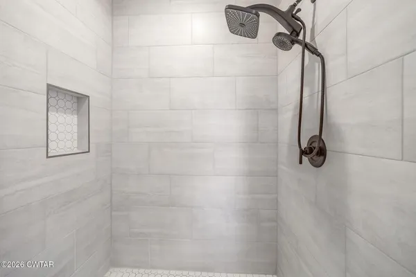 a view of walk in closet with clothes