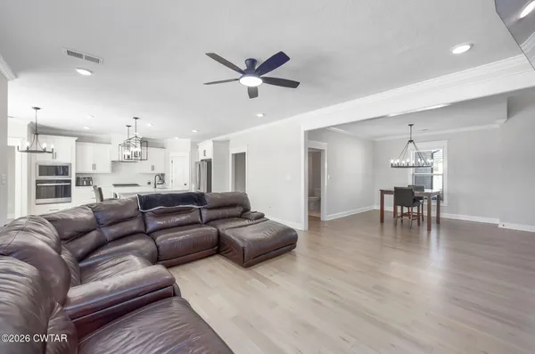 a living room with furniture and a chandelier