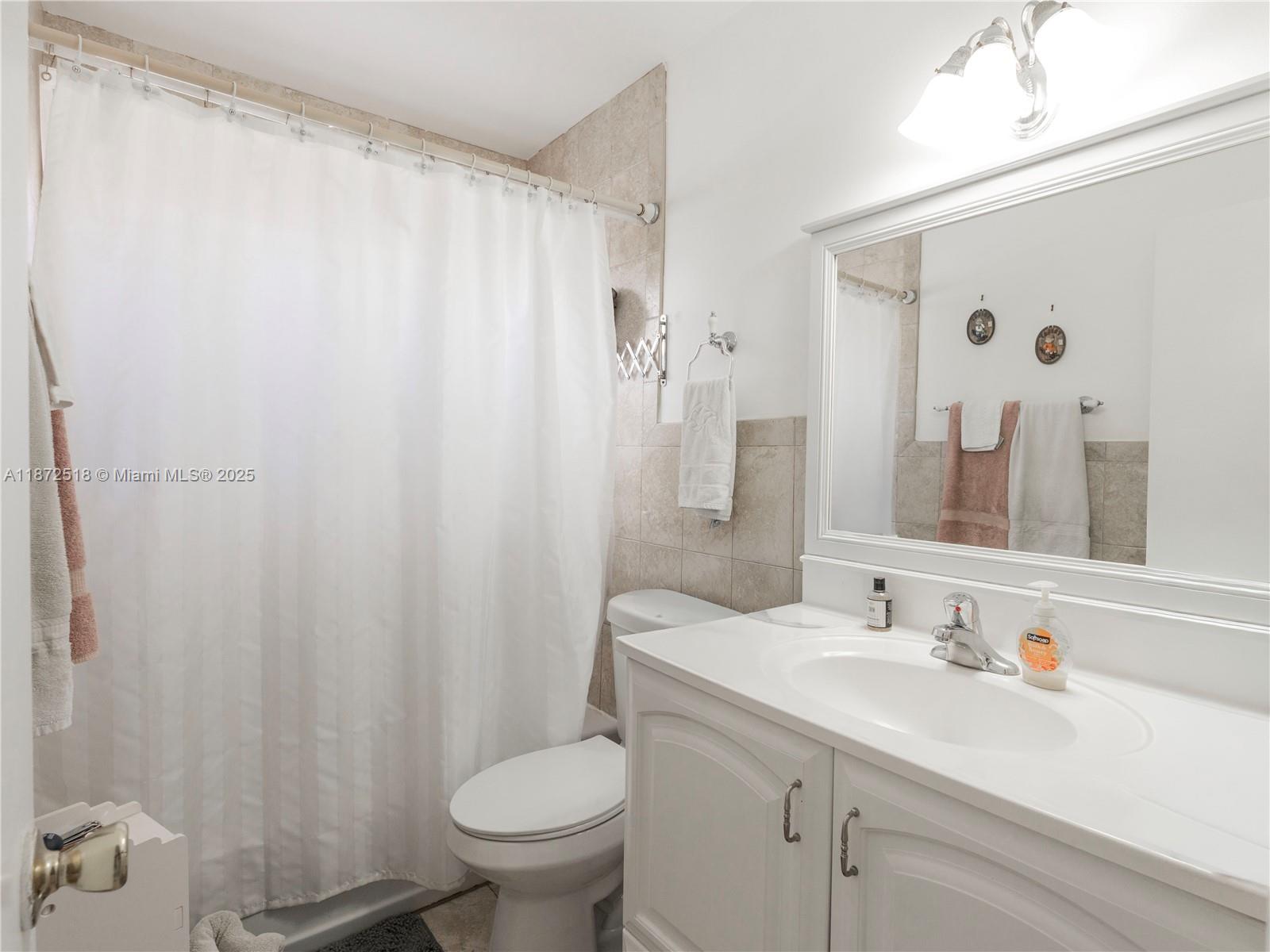 15275 Southwest 56th Terrace Miami, FL 33193 - Photo 15 of 32 a bathroom with a sink a toilet and shower