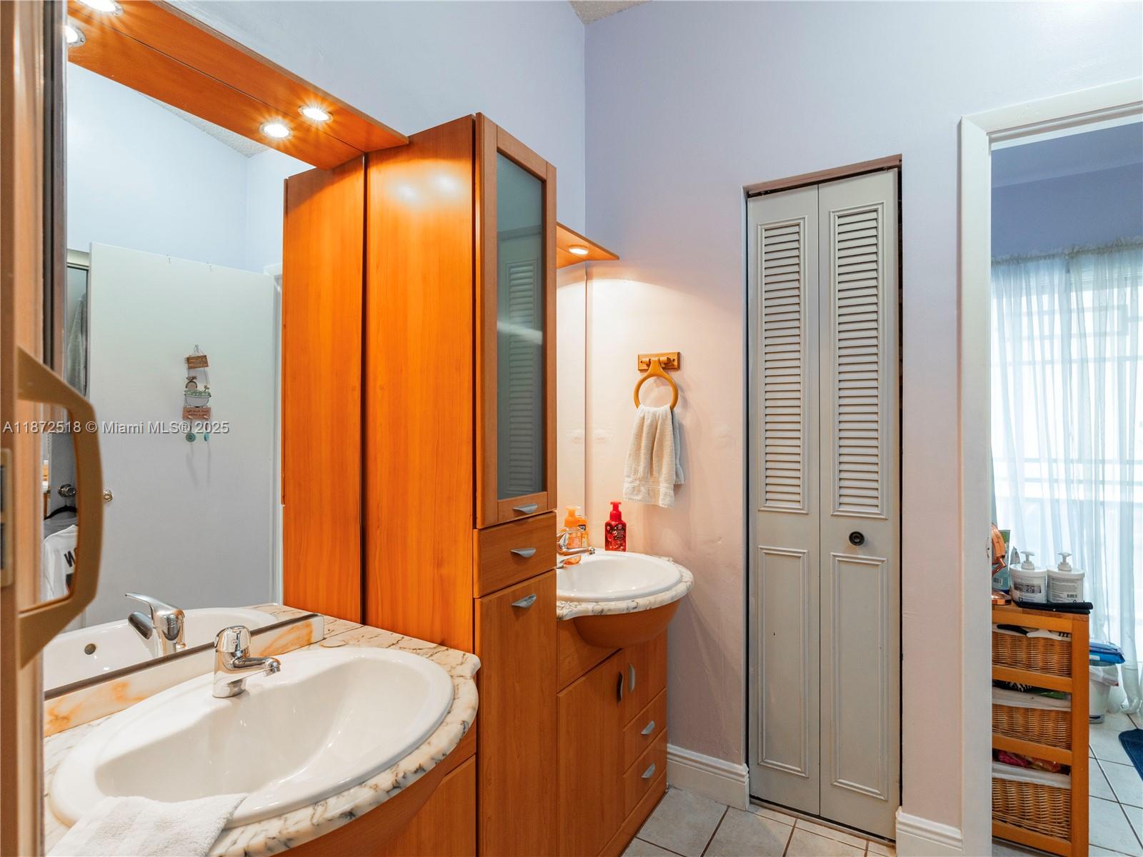 15275 Southwest 56th Terrace Miami, FL 33193 - Photo 16 of 32 a bathroom with a sink and a mirror