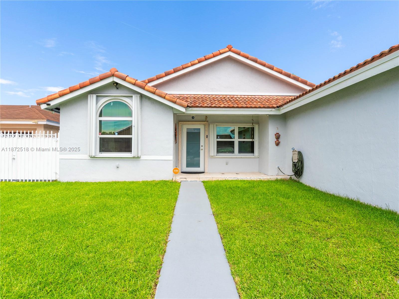 15275 Southwest 56th Terrace Miami, FL 33193 - Photo 2 of 32 a front view of a house with a yard